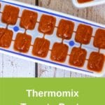 Thermomix tomato paste in ice cube trays on white wood table, green banner for pinterest