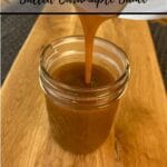 salted caramel maple sauce being poured from thermomix bowl into a jar on wooden board