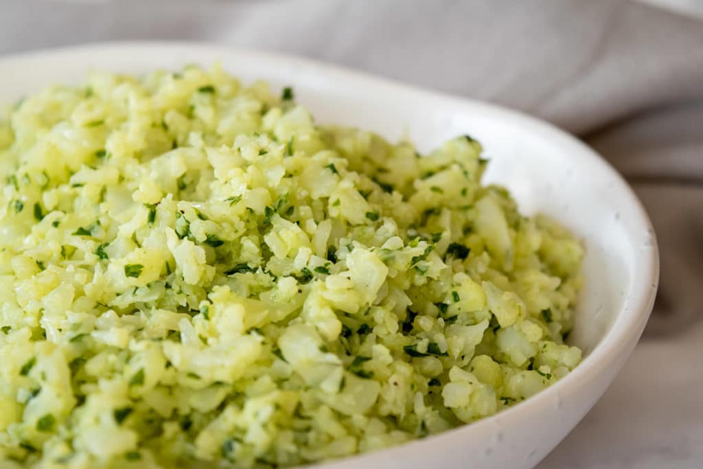 close up thermomix cauliflower rice in white dish, napkin behind