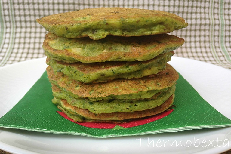 pile of green tinged spinach and corn pikelet batter made in Thermomix on green napkin with green and white squared background