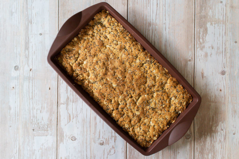 Thermomix Anzac slice in brown silicon form on white wood