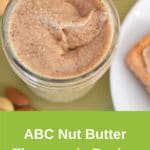 abc nut butter thermomix recipe, photo from above, nuts on green tablecloth around jar