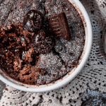 thermomix choc pudding in white bowl, with doily and spoon