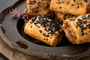 thermomix vegetarian sausage rolls close up on metal detailed plate