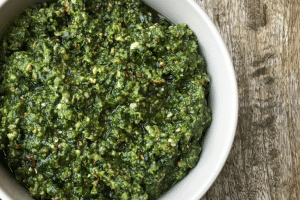 Close up Thermomix pesto in white dish on wooden surface