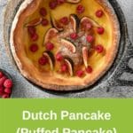 Dutch baby in cast iron pan on rustic background