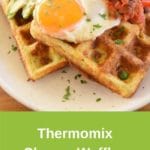 savoury waffles thermomix on white plate topped with fried egg and salsa, fork and parsley in background pin