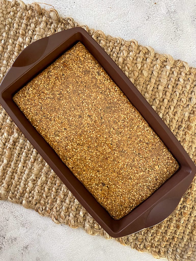 sesame bars in brown silicon slice form, on woven placemat, on grey table