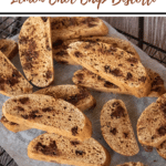 pinterest pin "thermobexta thermomix lemon choc chip biscotti" title, with biscotti on cooling rack on wooden background. Brown strip along bottom with thermobexta logo in it