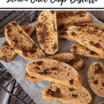 pinterest pin 'thermobexta thermomix lemon choc chip biscotti' title at top. biscotti laying on cooling rack on baking paper on wooden backdrop. Black strip along bottom with thermobexta logo in it