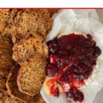 pinterest pin, 'thermomix warm Brie w/ Quick Christmas Jam wording up top, thermobexta logo down the bottom. Image is a close up of brie with some oozing out, topped with Christmas jam and alongside crackers. Brie is on top of baking paper