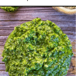 text 'thermomix hemp seed pesto' at top, image of close up of pesto on wooden table, green strip along bottom containing thermobexta logo