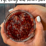 text 'Thermobexta thermomix fig, honey and lemon jam' at top, then image of jam in jar being held by two hands, Birdseye view. Thermobexta logo in black strip along bottom