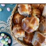 hot cross buns in basket with candied Easter eggs off to the side