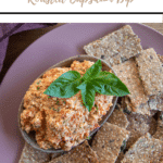 roasted capsicum dip pin with title up top and thermobexta logo underneath image of dip in a dish on a pink plate with crackers around it. Basil on top of dip.