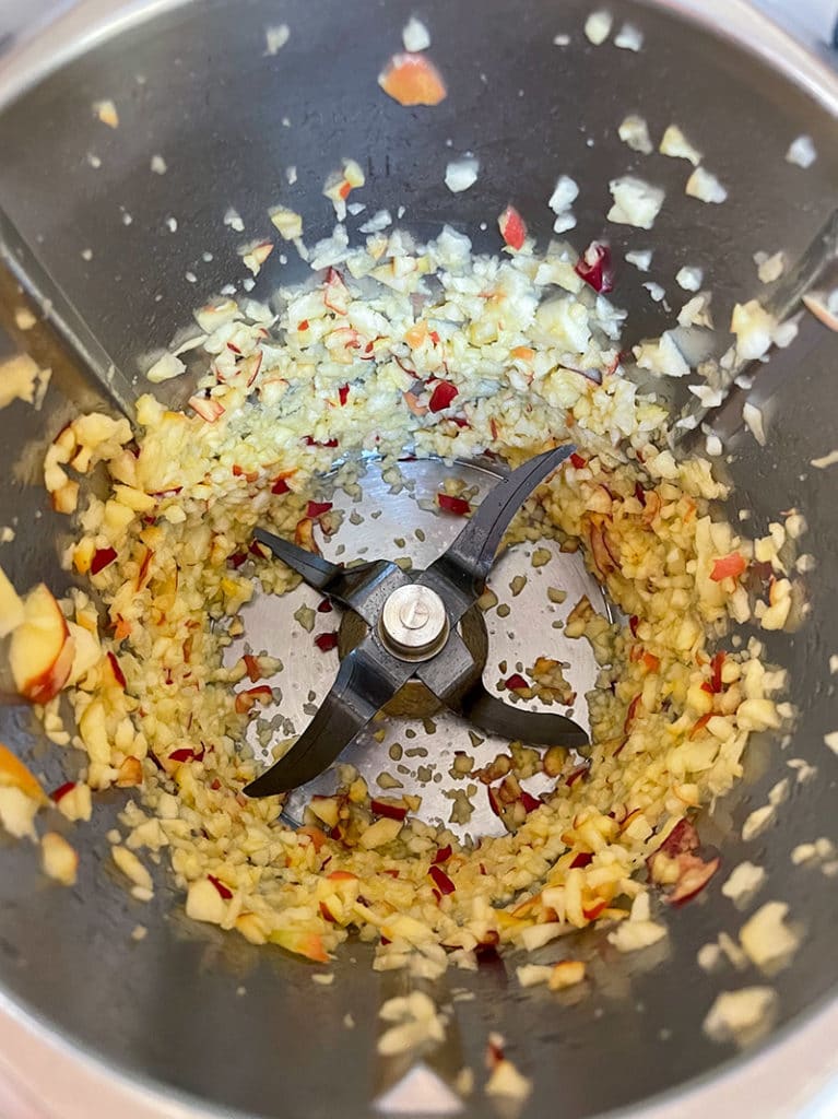 thermomix peach jam step one, chopping of apple into tiny pieces. Birdseye view down into thermomix bowl