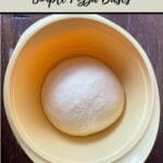 yellow bowl with ball of dough in it, on wooden bench. Wording above and below with recipe name and thermobexta logo