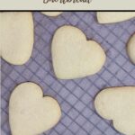 pinterest pin shortbread love hearts on baking paper on metal cooling rack