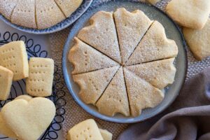 sliced round shortbread thermomix made, sitting on a round plate, surrounded by pieces of shortbread