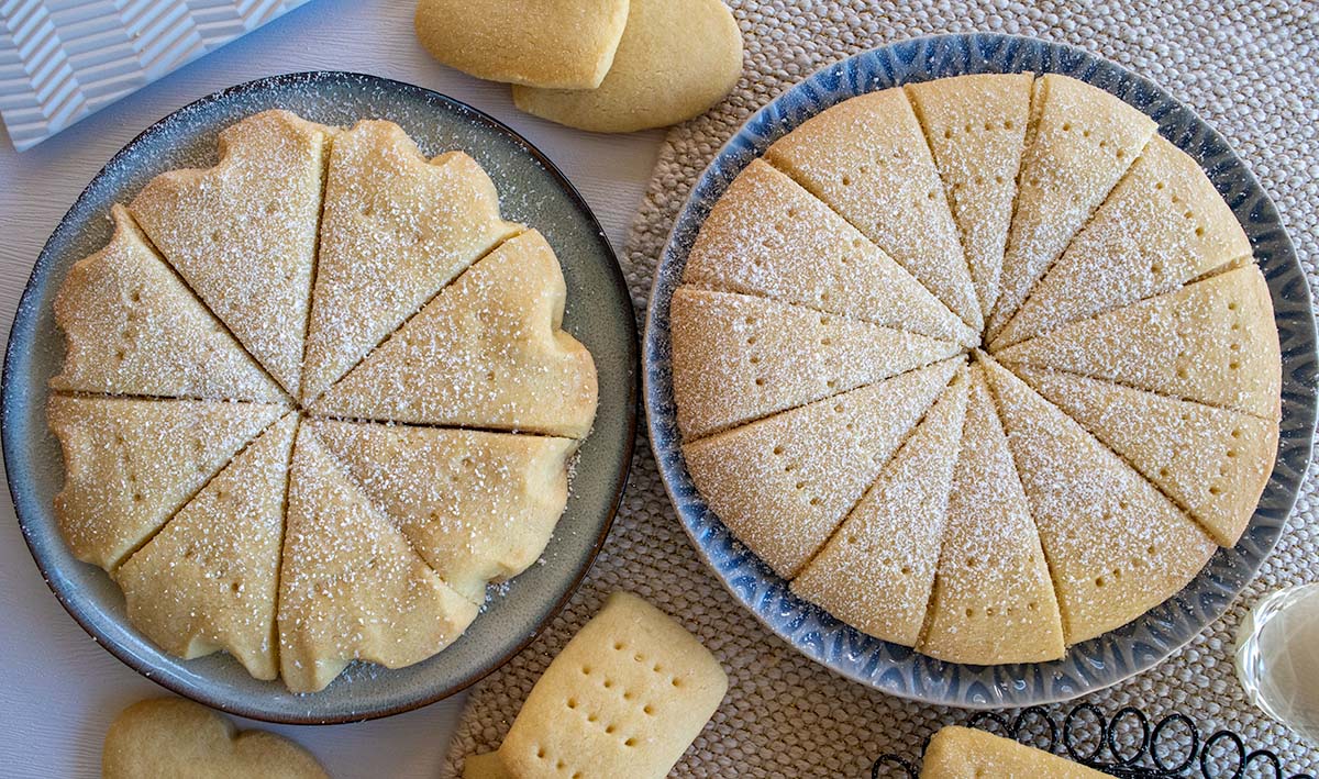 two plates of shortbread - large round discs dusted with icing sugar