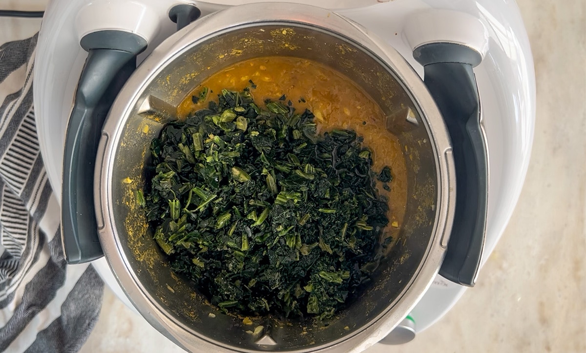 birdseye view into thermomix containing lentil spinach soup almost ready