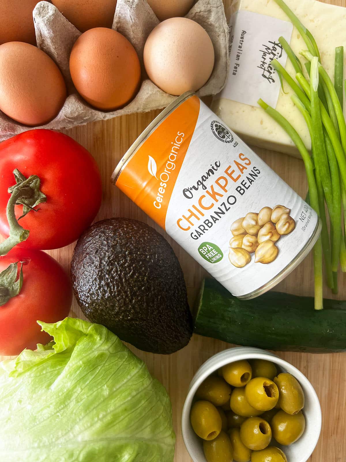 ingredients for cobb salad on wooden chopping board