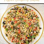 couscous salad pinterest pin photo of entire salad in glass dish with gold rim