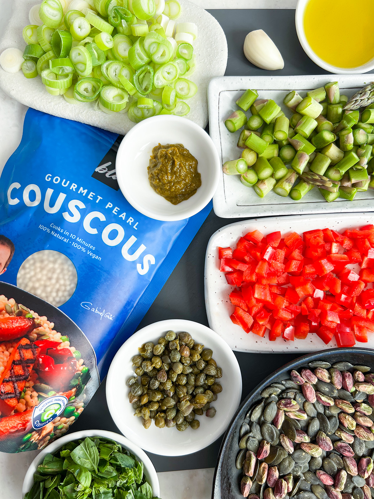 ingredients for couscous salad on grey and white bench top