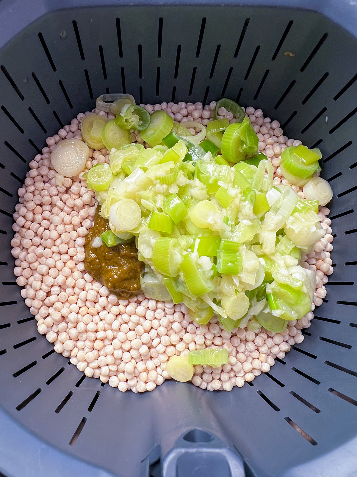 couscous and stock and spring onion in thermomix basket for salad